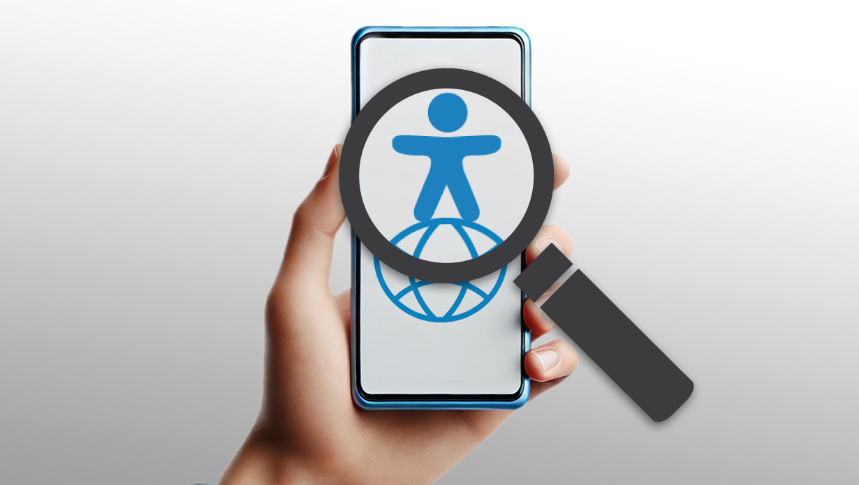 Das Männchen für Barrierefreiheit steht auf einer Weltkugel, im Display eines blauen Smartphones. Darüber ist eine Handlupe zu sehen. © Ingrid Glatz